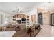 Open-concept living area with a fireplace and built-in shelving and seamless tile and carpet flooring at 3060 E Hope St, Mesa, AZ 85213