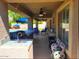 Covered outdoor kitchen with a built-in grill, sink, and counter space offers great space for cooking and entertaining at 3060 E Hope St, Mesa, AZ 85213