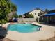 Sparkling pool surrounded by lush landscaping, offering a refreshing escape in a serene backyard setting at 3060 E Hope St, Mesa, AZ 85213