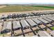 An aerial view of a neighborhood with desert landscaping and green farmland in the distance at 35266 W San Sisto Ave, Maricopa, AZ 85138