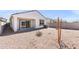 Backyard with gravel, a small patio, a small tree, and block wall at 35266 W San Sisto Ave, Maricopa, AZ 85138