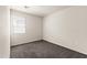 Neat bedroom featuring carpeted flooring, a window with blinds, and neutral wall color at 35266 W San Sisto Ave, Maricopa, AZ 85138