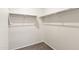 Walk-in closet with carpet flooring and hanging rods at 35266 W San Sisto Ave, Maricopa, AZ 85138
