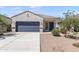 Charming single-story home featuring a stucco facade, desert landscaping, and a two-car garage at 35266 W San Sisto Ave, Maricopa, AZ 85138
