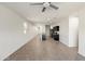 Spacious living area with tile flooring, recessed lighting, and an open layout adjacent to the kitchen at 35266 W San Sisto Ave, Maricopa, AZ 85138