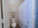 Cozy bathroom featuring a toilet and a shower/tub combo with a white shower curtain at 35721 N Zachary Rd, Queen Creek, AZ 85144