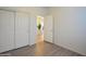 Bedroom with vinyl flooring, closet and an open door leading to the rest of the house at 35721 N Zachary Rd, Queen Creek, AZ 85144