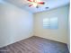 Comfortable bedroom with light-colored wood-look flooring, fan, and natural light from a window at 35721 N Zachary Rd, Queen Creek, AZ 85144