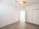Bright bedroom with vinyl flooring, and a large closet with sliding doors at 35721 N Zachary Rd, Queen Creek, AZ 85144