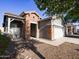 Charming single-story home with a brick facade and a well-maintained desert-style front yard at 35721 N Zachary Rd, Queen Creek, AZ 85144