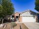 Inviting single-story home with a brick facade and a well-maintained desert-style front yard at 35721 N Zachary Rd, Queen Creek, AZ 85144