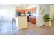 Charming kitchen featuring stainless steel appliances, a breakfast bar, and ample cabinet space at 35721 N Zachary Rd, Queen Creek, AZ 85144