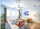Bright living room featuring stylish furniture, a ceiling fan, and neutral decor at 35721 N Zachary Rd, Queen Creek, AZ 85144