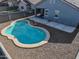 Backyard view with a refreshing blue swimming pool, desert landscaping, and an open patio at 35721 N Zachary Rd, Queen Creek, AZ 85144