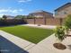 Enjoy the outdoors in your private backyard with artificial turf and lush greenery at 36114 W Vera Cruz Dr, Maricopa, AZ 85138