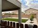 Beautiful backyard featuring a well-maintained lawn, mature trees, and a charming patio area perfect for outdoor entertaining at 36114 W Vera Cruz Dr, Maricopa, AZ 85138