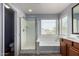 Bright bathroom with a separate shower, soaking tub, and double sink vanity, offering relaxation and convenience at 36114 W Vera Cruz Dr, Maricopa, AZ 85138