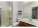 Well-lit bathroom featuring a glass enclosed shower, toilet, sink and a large mirror at 36114 W Vera Cruz Dr, Maricopa, AZ 85138