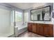 Bright bathroom with double vanity and shower-tub combination at 36114 W Vera Cruz Dr, Maricopa, AZ 85138
