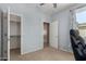 Bedroom with a ceiling fan, open doors, and a bright window offering natural light at 36114 W Vera Cruz Dr, Maricopa, AZ 85138