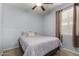 Cozy bedroom with neutral gray walls, a queen bed and a large sunny window at 36114 W Vera Cruz Dr, Maricopa, AZ 85138