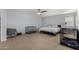 Spacious bedroom with large bed, ceiling fan, and plenty of natural light at 36114 W Vera Cruz Dr, Maricopa, AZ 85138