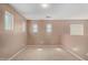 Bright bonus room with multiple windows, neutral walls, and plush carpeting at 36114 W Vera Cruz Dr, Maricopa, AZ 85138