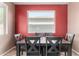Formal dining room with wood table and gray chairs below a large window at 36114 W Vera Cruz Dr, Maricopa, AZ 85138