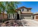 Charming two-story home with desert landscaping, a two-car garage, and a welcoming front entrance at 36114 W Vera Cruz Dr, Maricopa, AZ 85138