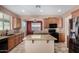 Well-lit kitchen featuring granite countertops, stainless steel appliances, and an island, great for cooking at 36114 W Vera Cruz Dr, Maricopa, AZ 85138