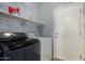 Laundry room with newer front loading appliances and a storage shelf at 36114 W Vera Cruz Dr, Maricopa, AZ 85138