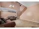 Spacious living room with two-story ceilings, tile entry, carpet, and a staircase at 36114 W Vera Cruz Dr, Maricopa, AZ 85138