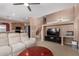 Open-concept living room with stairs, neutral paint, and seamless flow to the kitchen, ideal for modern living at 36114 W Vera Cruz Dr, Maricopa, AZ 85138