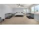 Large bedroom with natural light and ceiling fan with two dog kennels on either side of the bed at 36114 W Vera Cruz Dr, Maricopa, AZ 85138