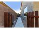 Side yard with pavers, desert landscaping, and secure gate at 36114 W Vera Cruz Dr, Maricopa, AZ 85138