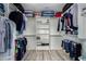 Spacious walk-in closet with ample storage and shelving, as well as multiple clothes and bags at 36114 W Vera Cruz Dr, Maricopa, AZ 85138