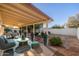 Inviting backyard with covered patio, fire pit, and ample space for outdoor relaxation and entertaining at 3624 E Hearn Rd, Phoenix, AZ 85032