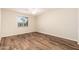 Cozy bedroom featuring sleek wood floors, neutral walls, and an abundance of natural light at 3624 E Hearn Rd, Phoenix, AZ 85032
