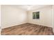 Well-lit bedroom showcasing wood flooring and a window with natural light at 3624 E Hearn Rd, Phoenix, AZ 85032