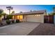 View of single-story home featuring a two-car garage and a spacious concrete driveway at 3624 E Hearn Rd, Phoenix, AZ 85032