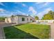 Expansive backyard with lush green grass, complemented by a modern, neutral-toned home and an inviting pool at 4107 E Edgemont Ave, Phoenix, AZ 85008