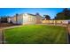 Lush backyard featuring a large lawn, a pool with an attached spa, and modern exterior lighting at 4107 E Edgemont Ave, Phoenix, AZ 85008