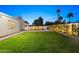 Expansive backyard with a lush lawn, featuring a pool and privacy landscaping at 4107 E Edgemont Ave, Phoenix, AZ 85008