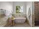 Bright bathroom features soaking tub under window and elegant tiled shower at 4107 E Edgemont Ave, Phoenix, AZ 85008
