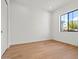 Neutral bedroom featuring wood floors, a large window and bright, white walls at 4107 E Edgemont Ave, Phoenix, AZ 85008