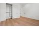 Clean bedroom featuring wood floors, closet with sliding doors and crisp, white walls at 4107 E Edgemont Ave, Phoenix, AZ 85008