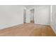 A pristine, empty bedroom features an open door and hardwood floors at 4107 E Edgemont Ave, Phoenix, AZ 85008