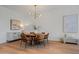 Dining room features modern chandelier and adjacent to a living space at 4107 E Edgemont Ave, Phoenix, AZ 85008