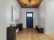 Inviting foyer with wood floors, a stylish console table, and a striking wood-paneled ceiling at 4107 E Edgemont Ave, Phoenix, AZ 85008
