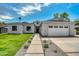 Beautiful home featuring a manicured lawn, stylish stone walkway and attached two car garage at 4107 E Edgemont Ave, Phoenix, AZ 85008